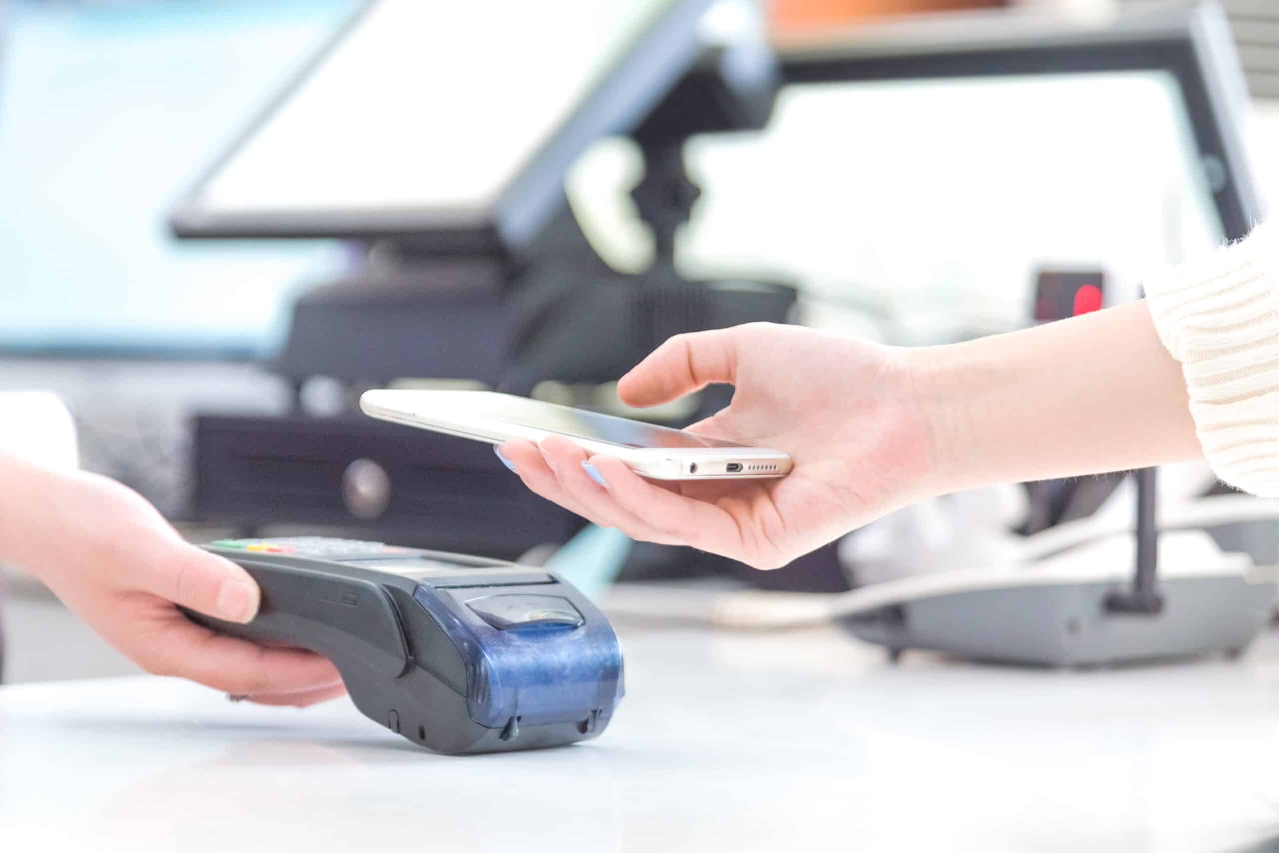 Person using smart phone to perform contactless payment